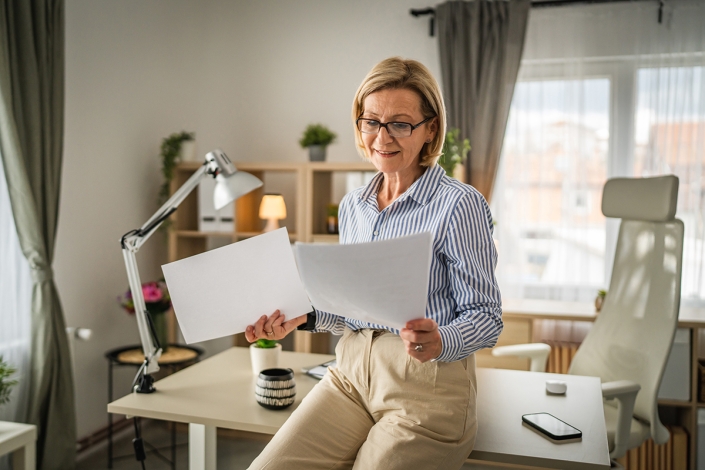 Mature,Woman,Read,Contract,Document,Paper,At,Office,Happy,Smile