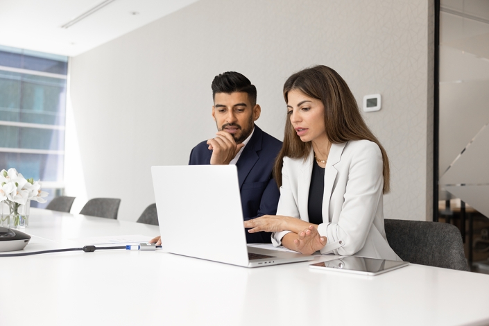 Diverse,Couple,Of,Serious,Managers,Talking,At,Laptop,,Pointing,At